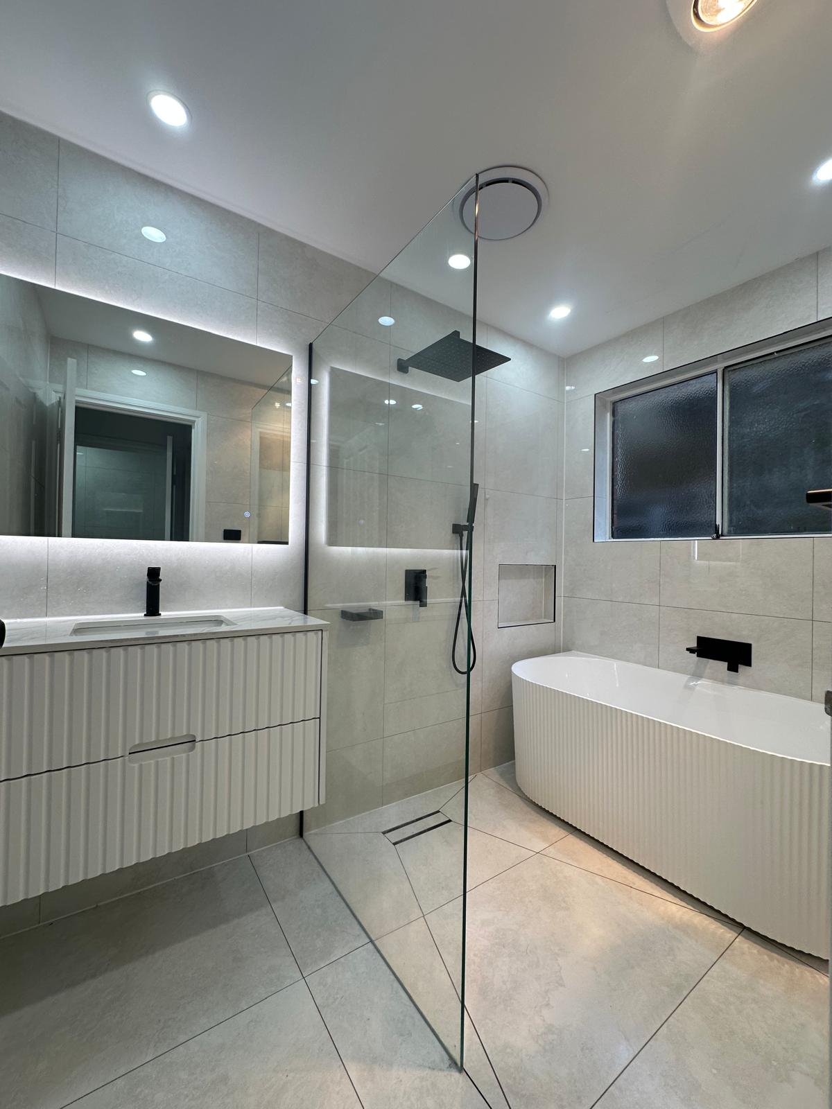 Small bathroom, BIG transformation! 🚿 We&#039;ve completely revamped this cramped bathroom into a modern wet room with frameless glass shower screens, premium light tiles, and high-end matte black fixtures.